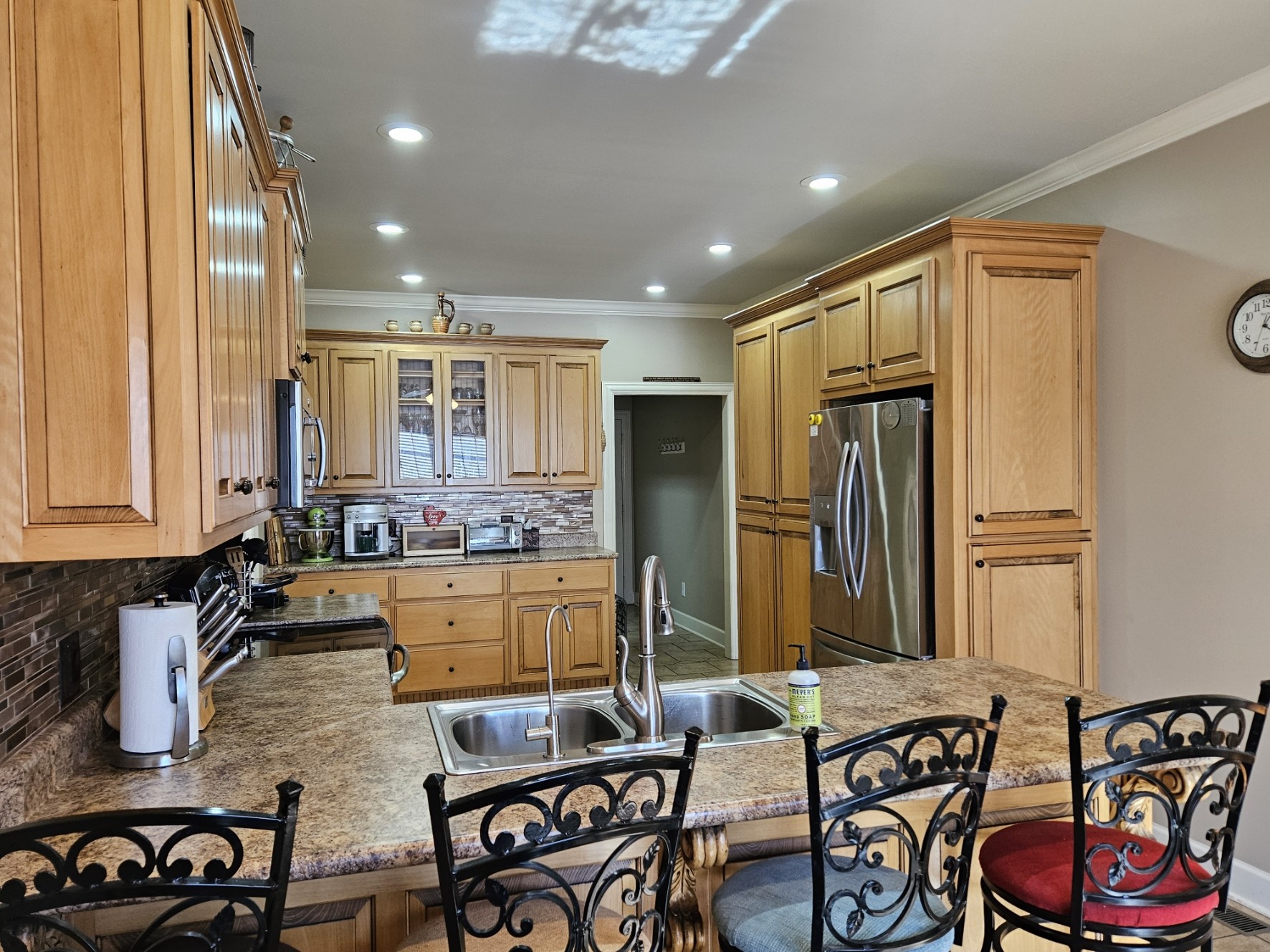 26121 Pheasant Run Ardmore, TN 38449 - Photo 18 of 46 a kitchen with sink refrigerator dining table and chairs