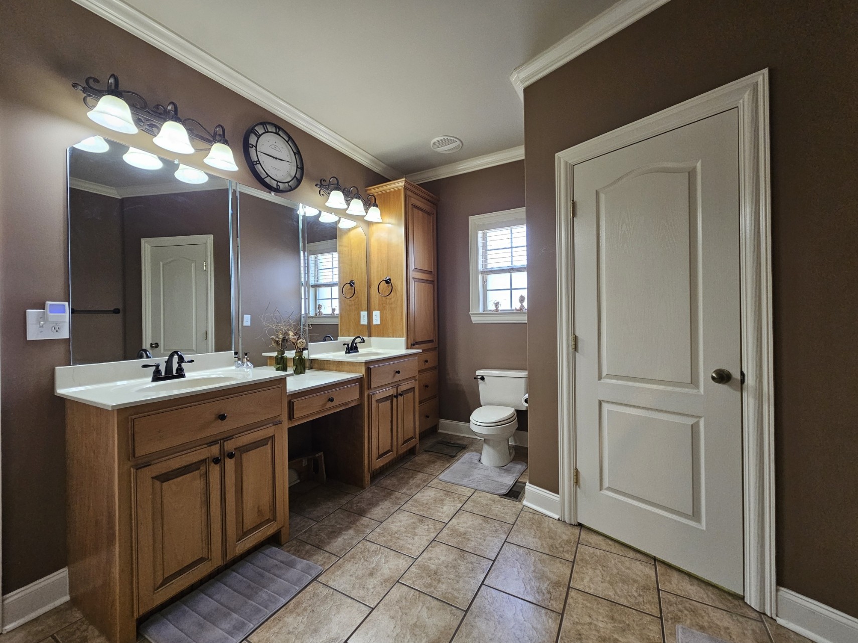 26121 Pheasant Run Ardmore, TN 38449 - Photo 30 of 46 a large bathroom with a double vanity sink a toilet a mirror and a vanity