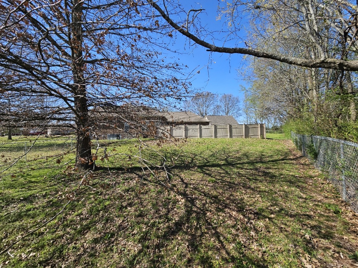 26121 Pheasant Run Ardmore, TN 38449 - Photo 46 of 46 a view of a big yard with large tree and a wooden fence