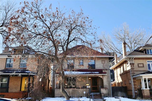 a view of a house with a large tree