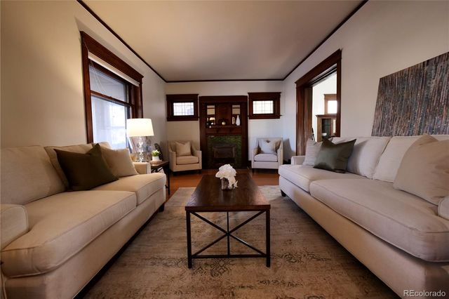 a living room with furniture and a fireplace