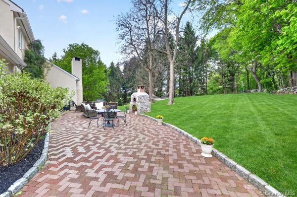 9 Hickory Ridge Road Brewster, NY 10509 - Photo 41 of 50 a view of a patio with table and chairs potted plants and large tree