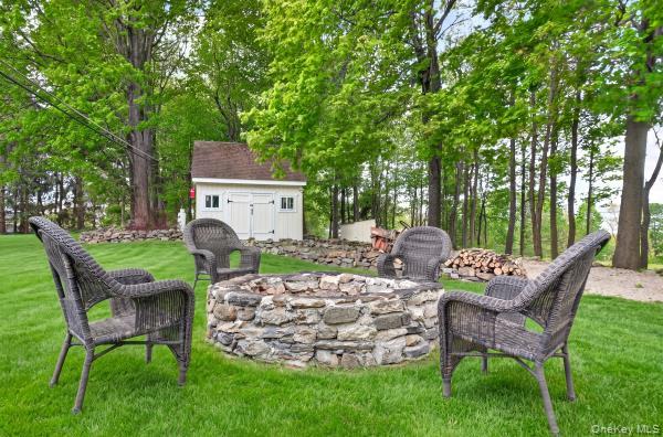 9 Hickory Ridge Road Brewster, NY 10509 - Photo 45 of 50 a view of a chairs and table in backyard of the house