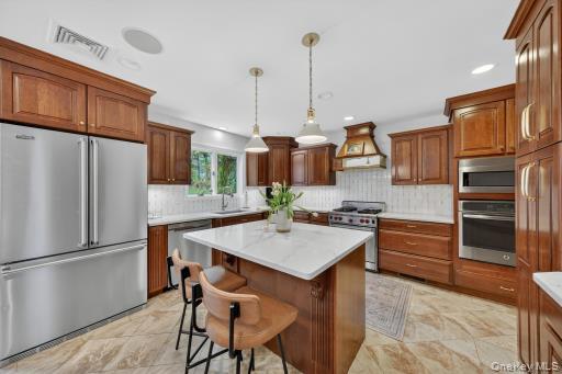 9 Hickory Ridge Road Brewster, NY 10509 - Photo 5 of 50 a kitchen with stainless steel appliances a stove a refrigerator and a sink