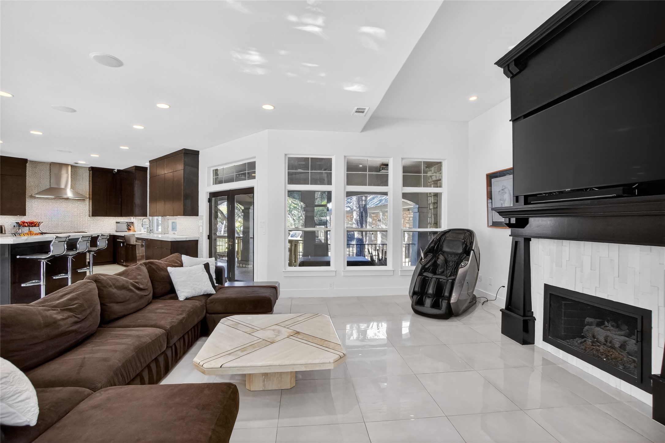 3627 Stoneridge Road Austin, TX 78746 - Photo 37 of 40 Living room with a fireplace, light tile patterned floors, and recessed lighting