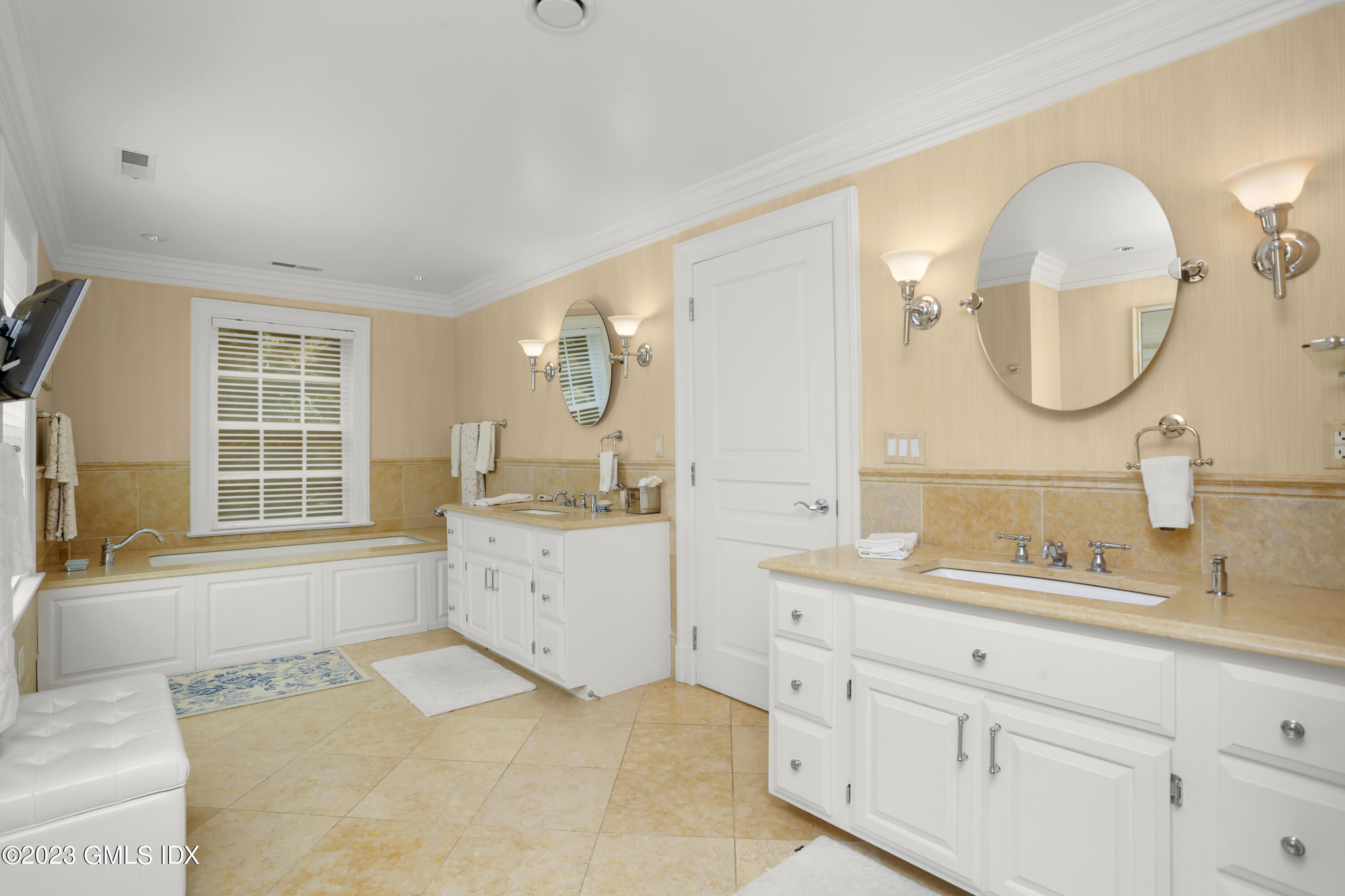 30 Burning Tree Road Greenwich, CT 06830 - Photo 13 of 33 a spacious bathroom with a granite countertop sink mirror and a bathtub