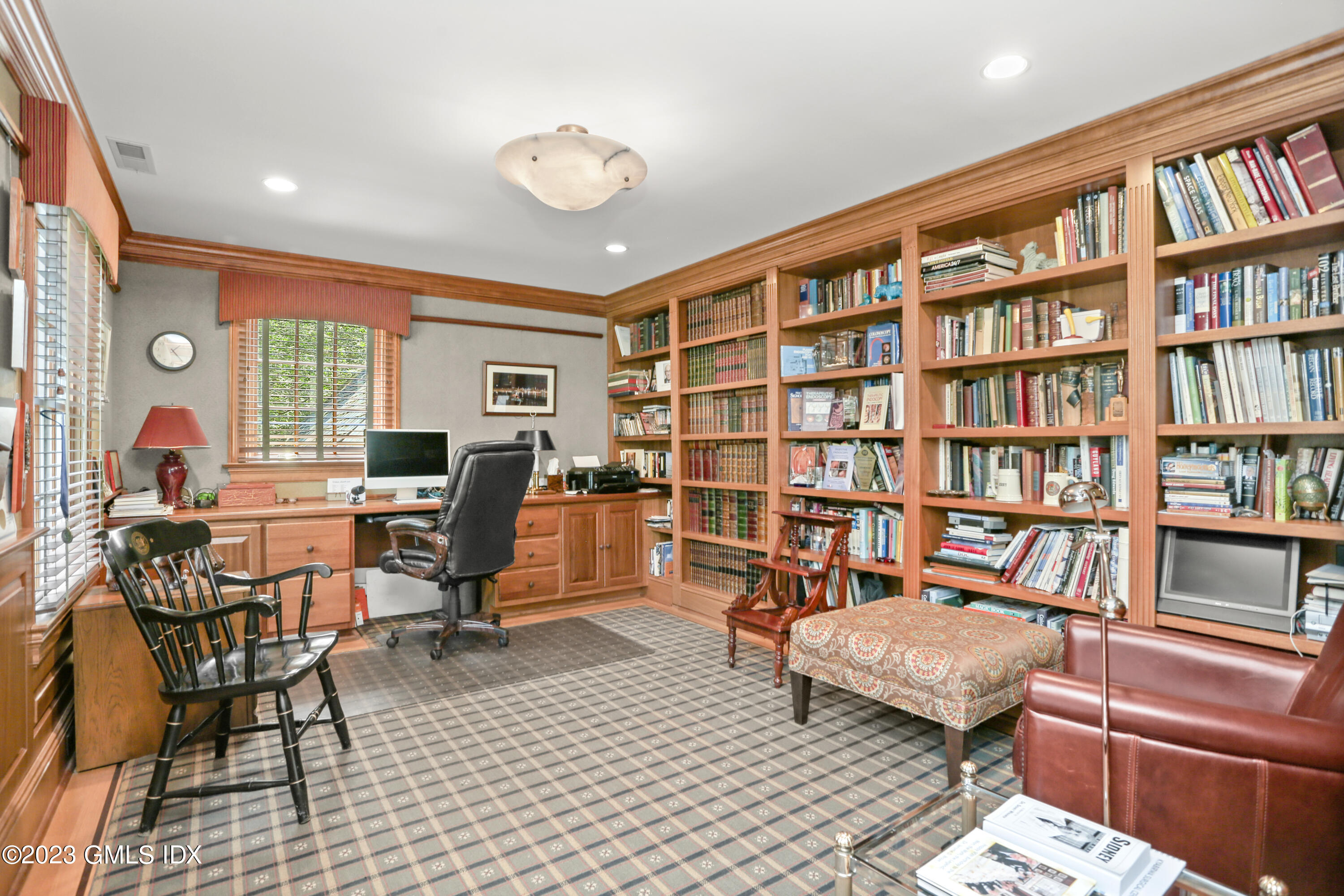 30 Burning Tree Road Greenwich, CT 06830 - Photo 19 of 33 a living room with furniture a rug and a book shelf