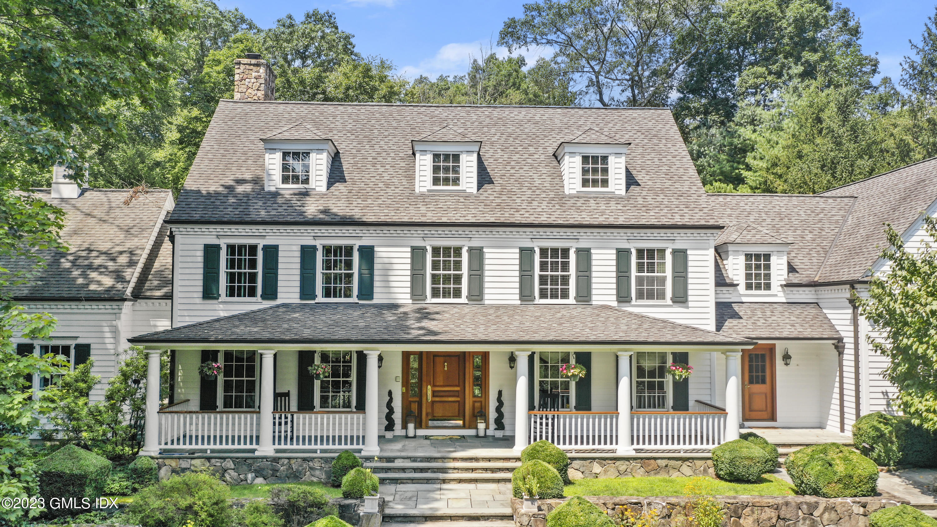 30 Burning Tree Road Greenwich, CT 06830 - Photo 2 of 33 a front view of a house with a garden