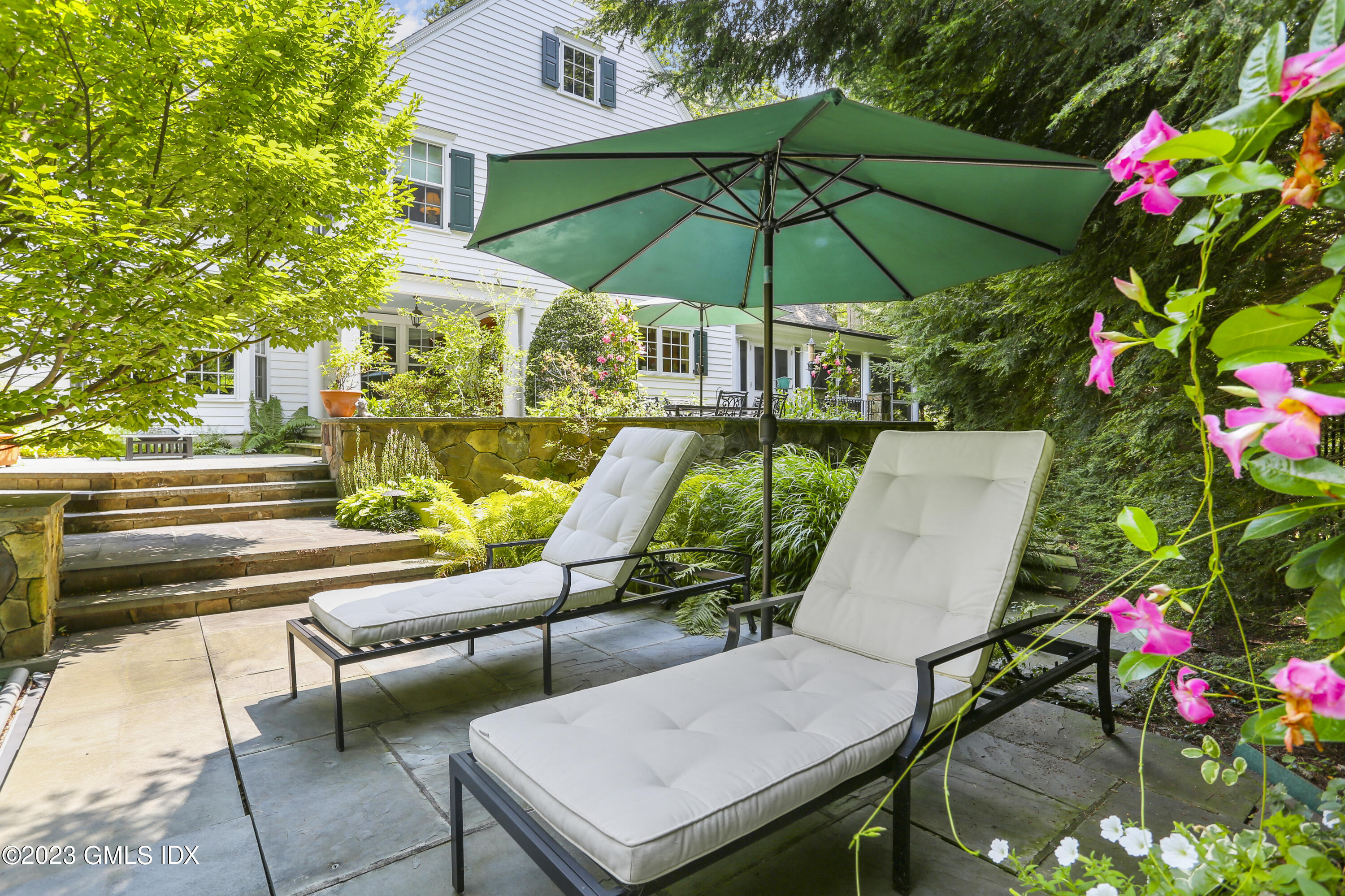 30 Burning Tree Road Greenwich, CT 06830 - Photo 26 of 33 a view of an outdoor sitting area with chairs and umbrella