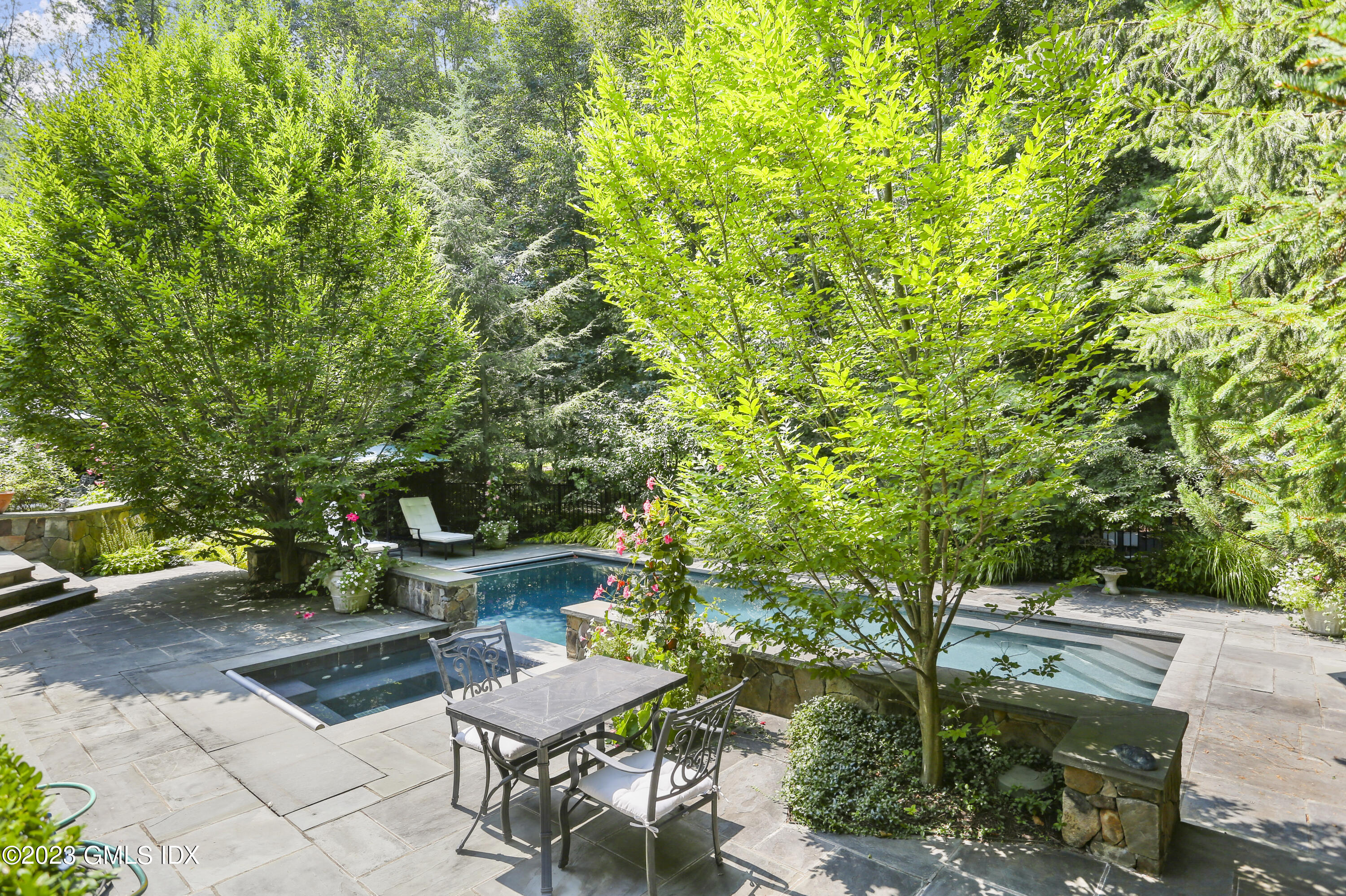 30 Burning Tree Road Greenwich, CT 06830 - Photo 27 of 33 a view of a patio with table and chairs and potted plants