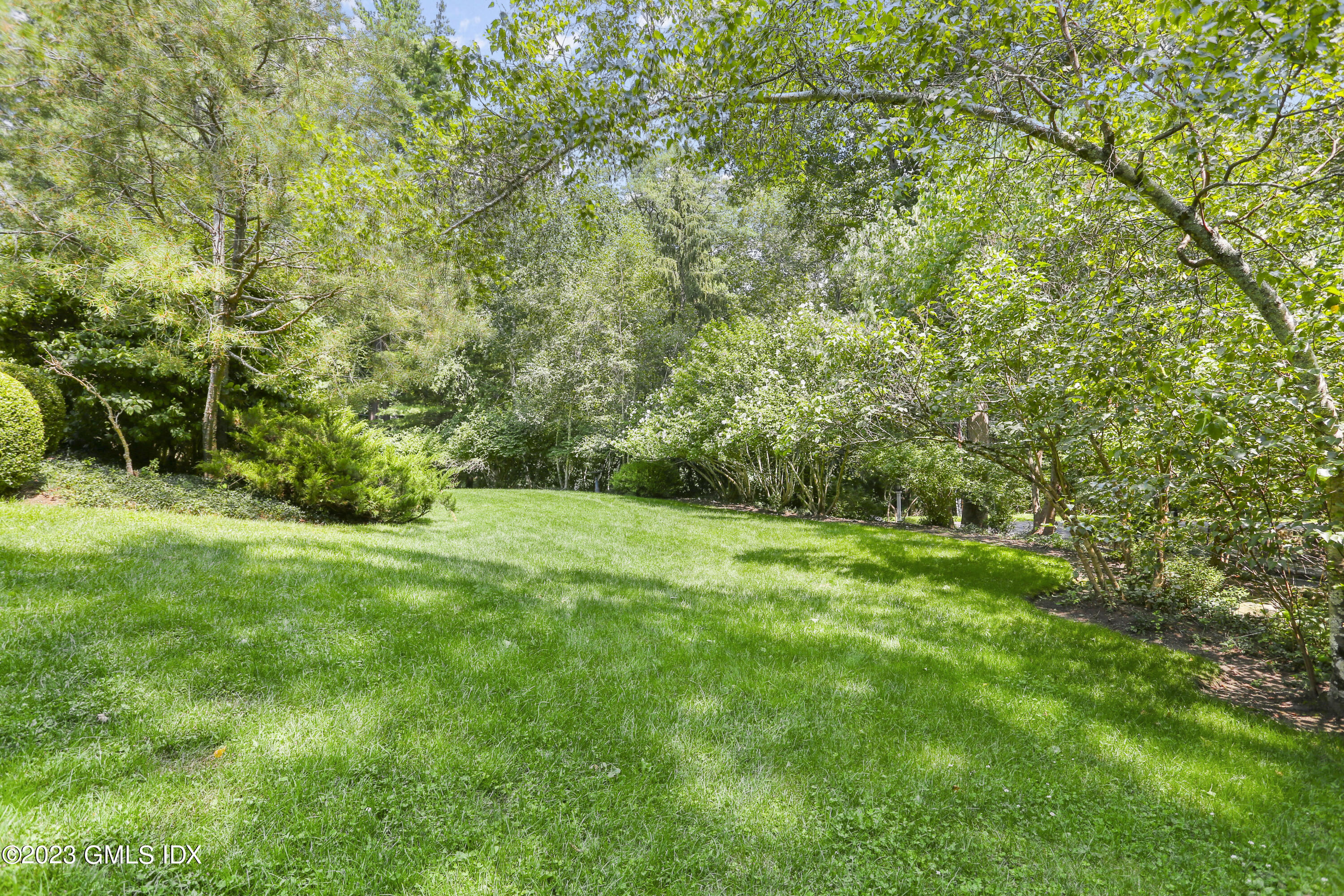 30 Burning Tree Road Greenwich, CT 06830 - Photo 31 of 33 a view of a yard with a trees