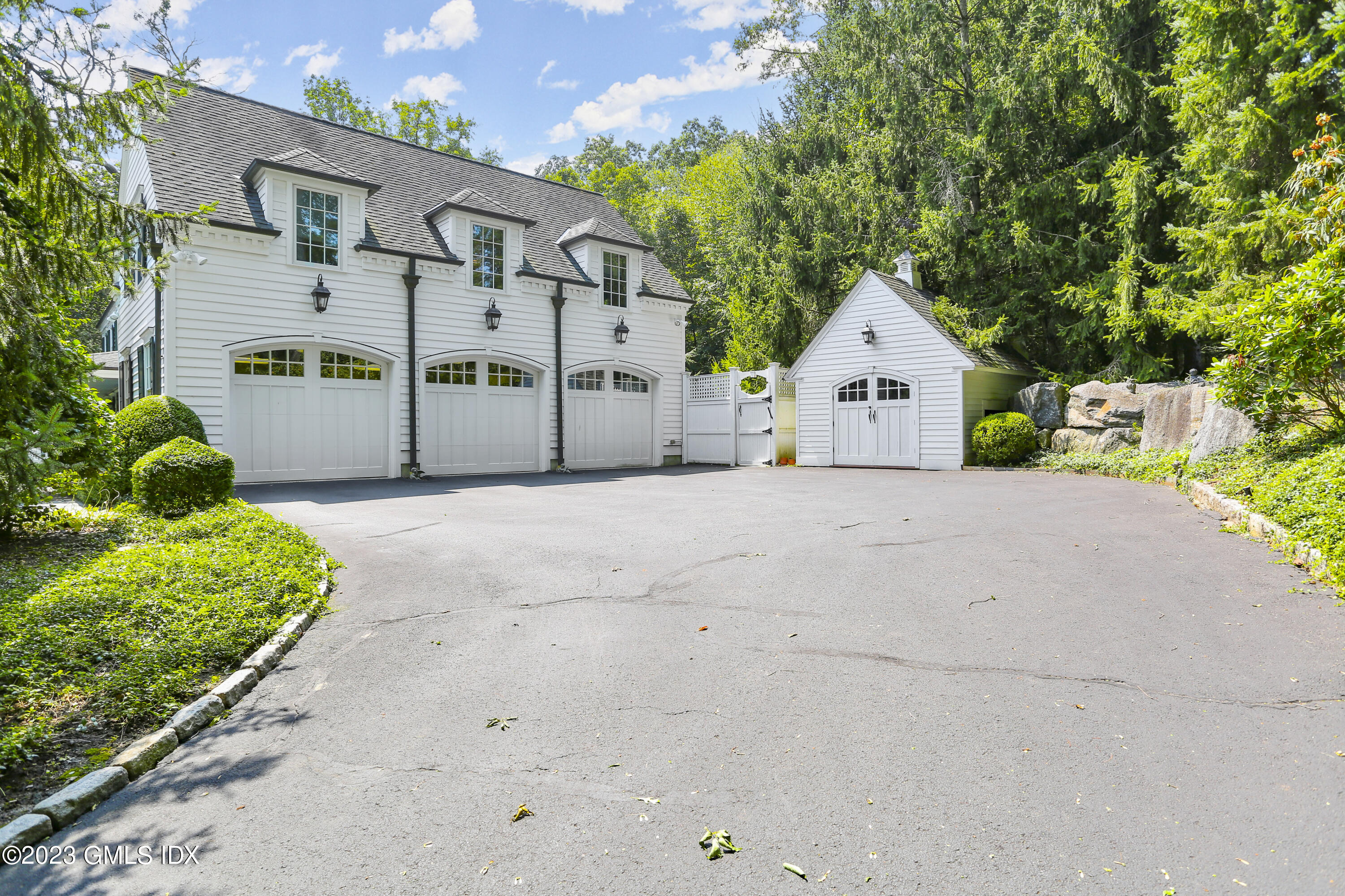 30 Burning Tree Road Greenwich, CT 06830 - Photo 32 of 33 a view of a house with a yard and potted plants