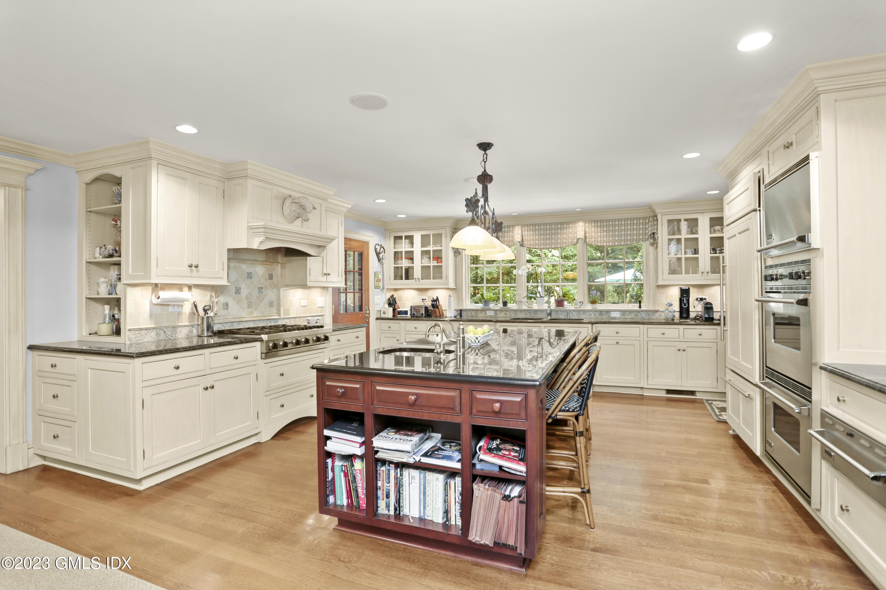30 Burning Tree Road Greenwich, CT 06830 - Photo 6 of 33 a kitchen with stainless steel appliances granite countertop a kitchen island a stove a sink a dining table and chairs