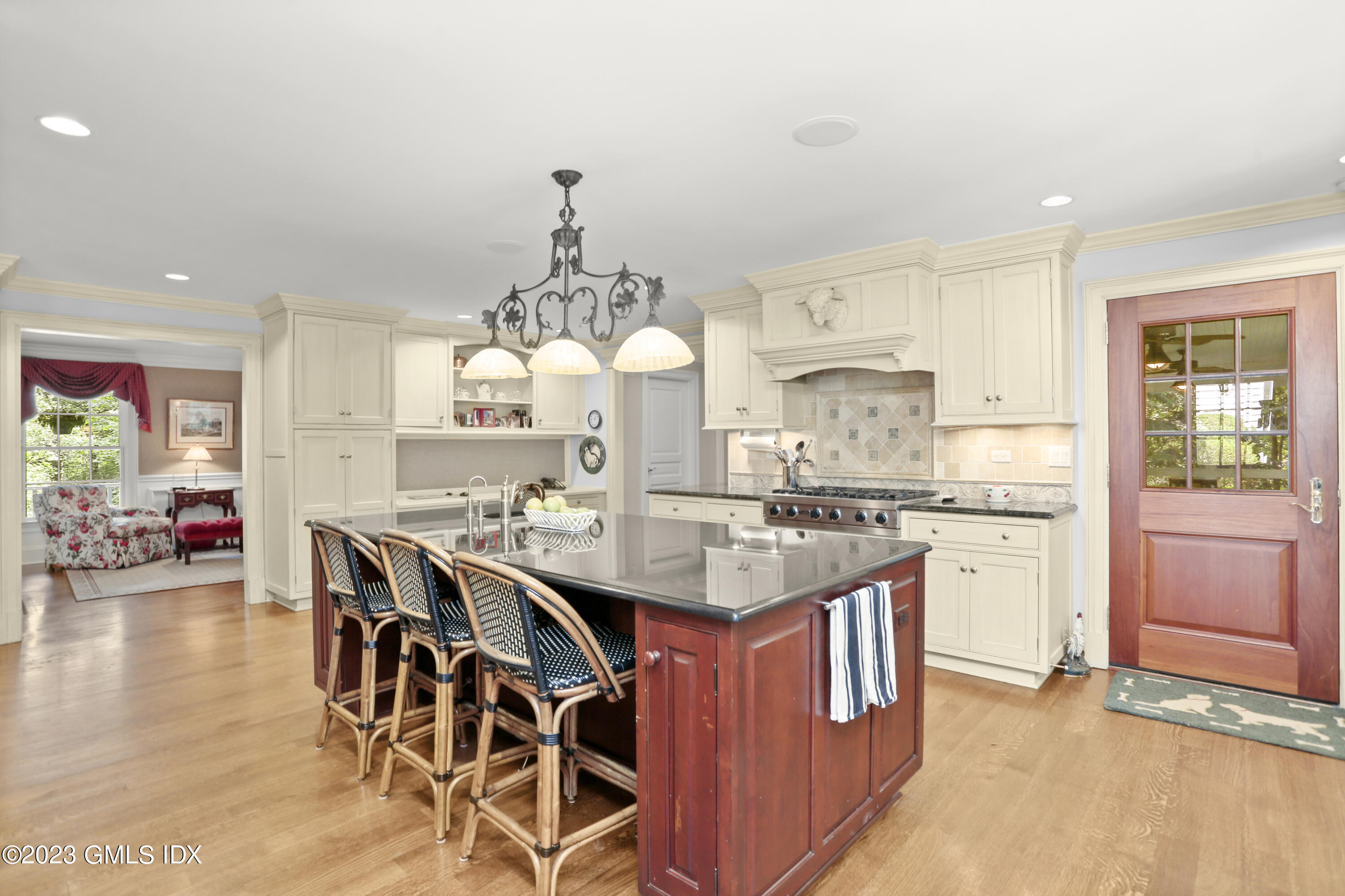 30 Burning Tree Road Greenwich, CT 06830 - Photo 7 of 33 a kitchen with stainless steel appliances a dining table chairs and stove top oven