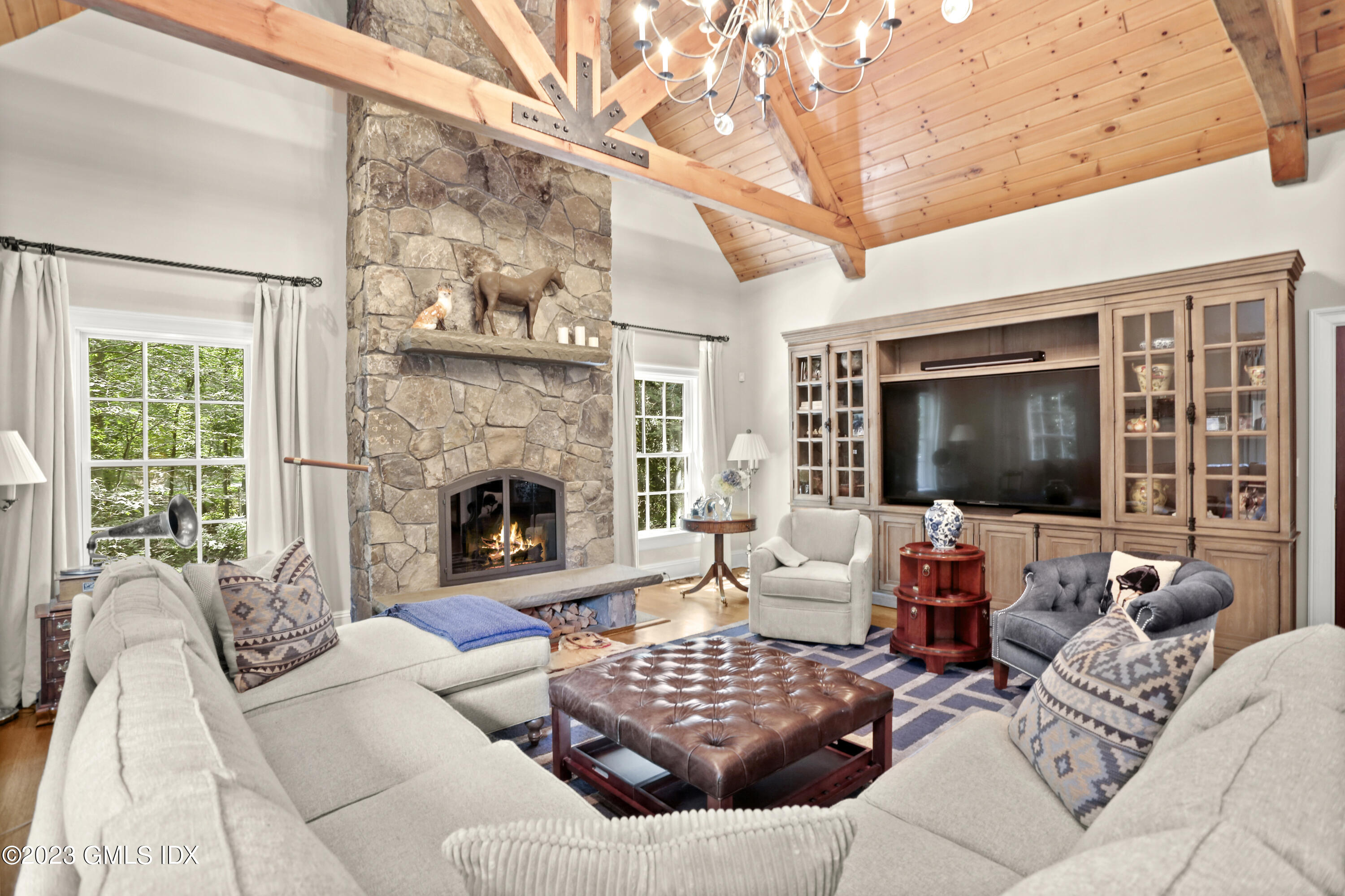 30 Burning Tree Road Greenwich, CT 06830 - Photo 9 of 33 a living room with furniture large window and a fireplace