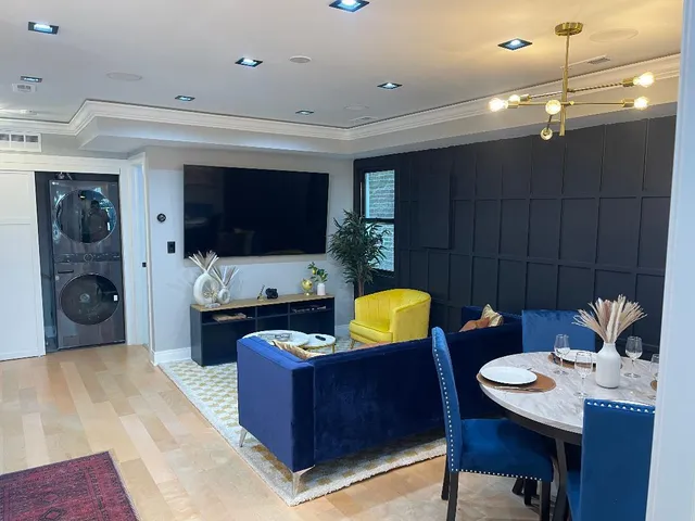 a kitchen with sink a refrigerator and chairs