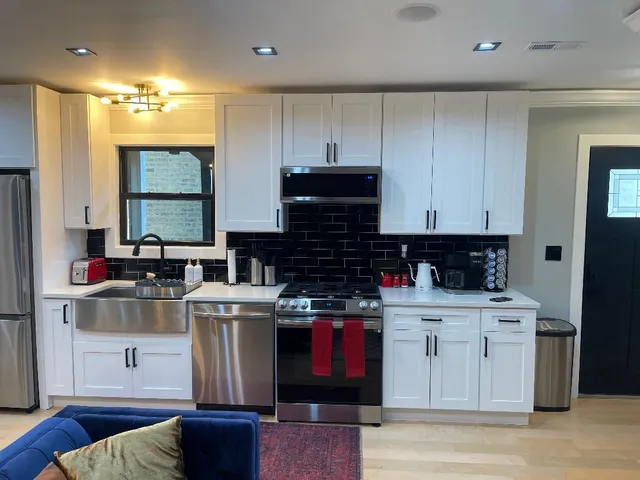 a kitchen with stainless steel appliances granite countertop a stove and a refrigerator