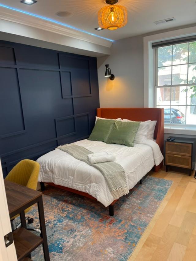 650 North Talman Avenue, Unit 1F Chicago, IL 60612 - Photo 4 of 9 a bedroom with a bed and chair