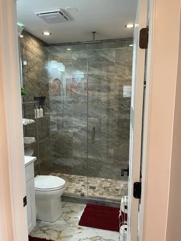 a bathroom with a shower and a toilet