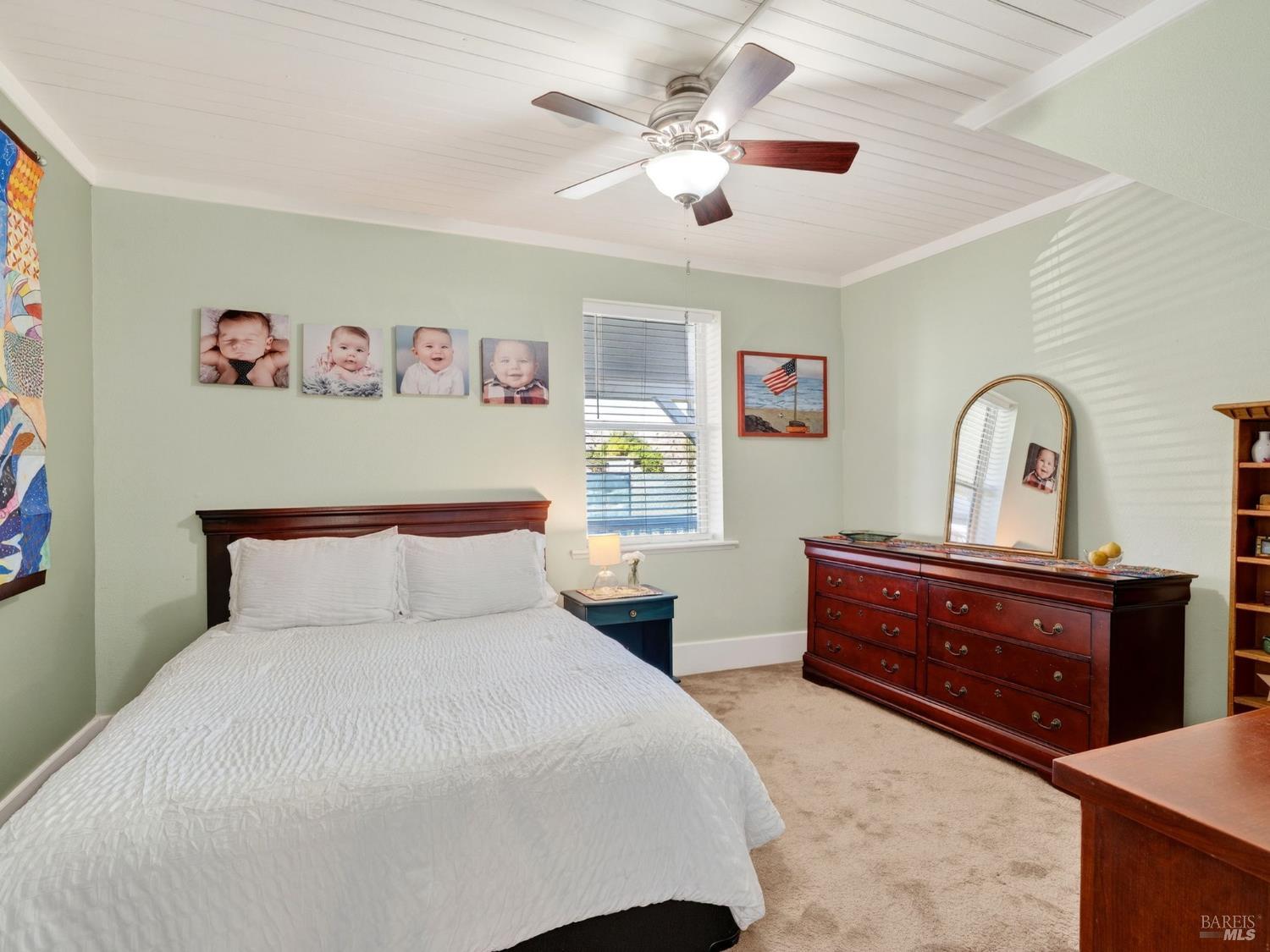 71 Crowell Street Geyserville, CA 95441 - Photo 13 of 42 a bedroom with a large bed and a chandelier