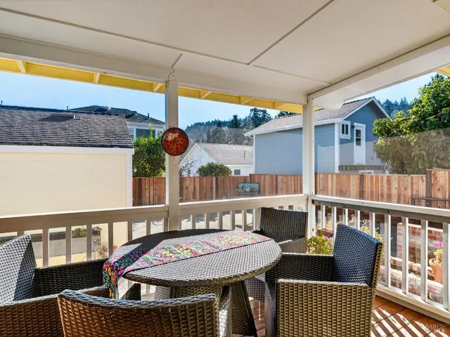 a view of a balcony with wooden floor and stairs