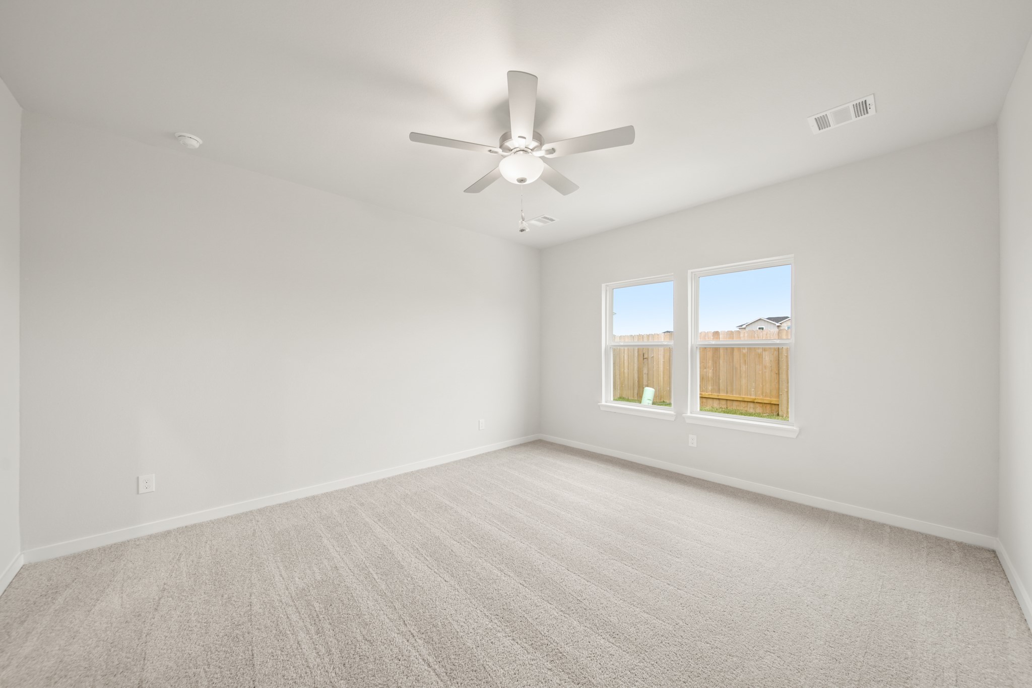 306 Bennett Street Angleton, TX 77515 - Photo 11 of 29 an empty room with a window and a ceiling fan