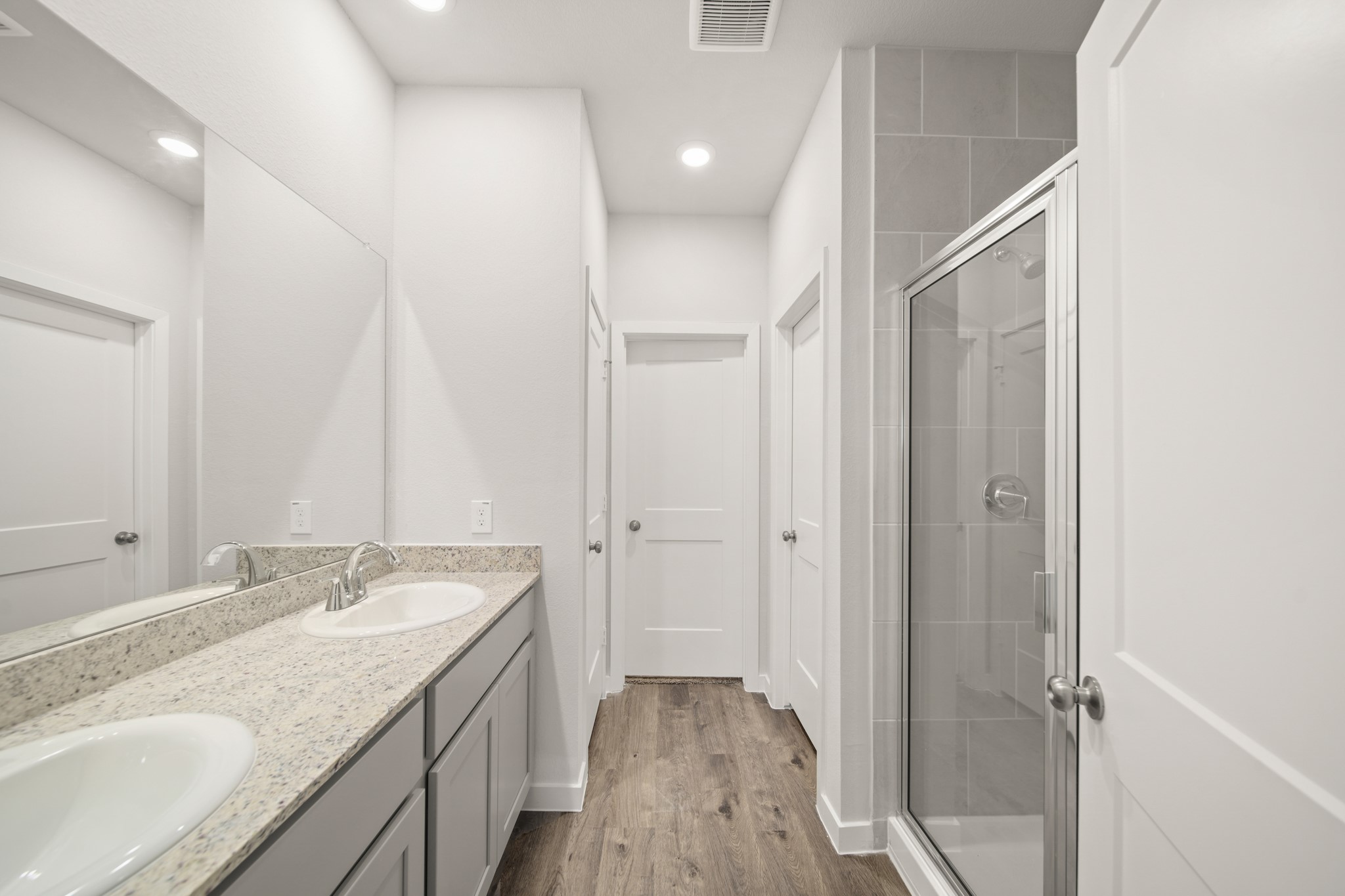 306 Bennett Street Angleton, TX 77515 - Photo 12 of 29 a bathroom with a granite countertop sink a mirror and a shower