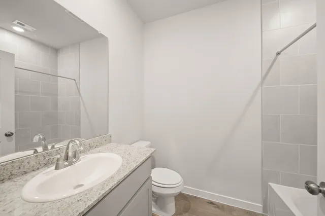 a bathroom with a sink toilet and a mirror