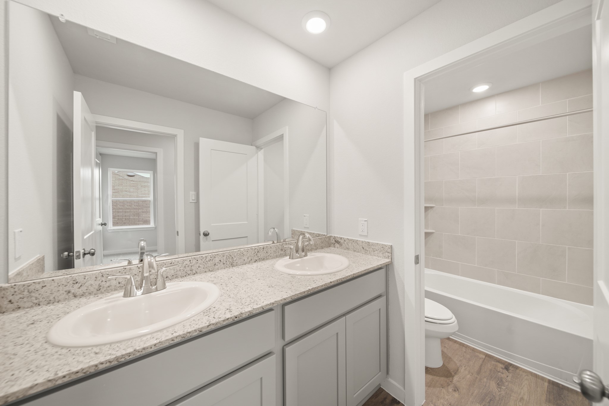 306 Bennett Street Angleton, TX 77515 - Photo 21 of 29 a bathroom with a granite countertop sink toilet and shower