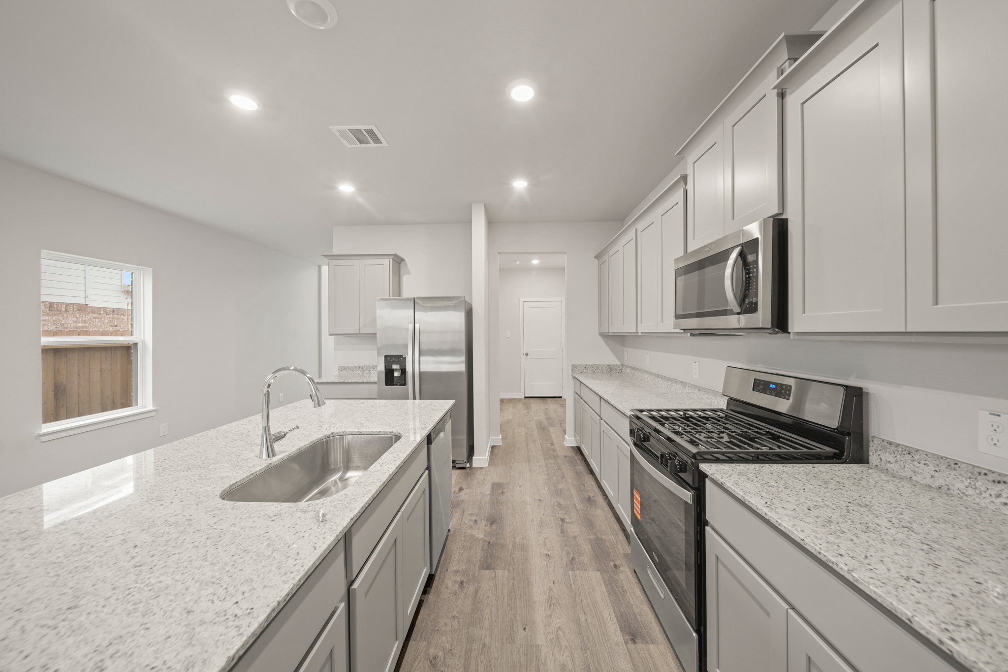 306 Bennett Street Angleton, TX 77515 - Photo 6 of 29 a kitchen with stainless steel appliances granite countertop sink stove and refrigerator