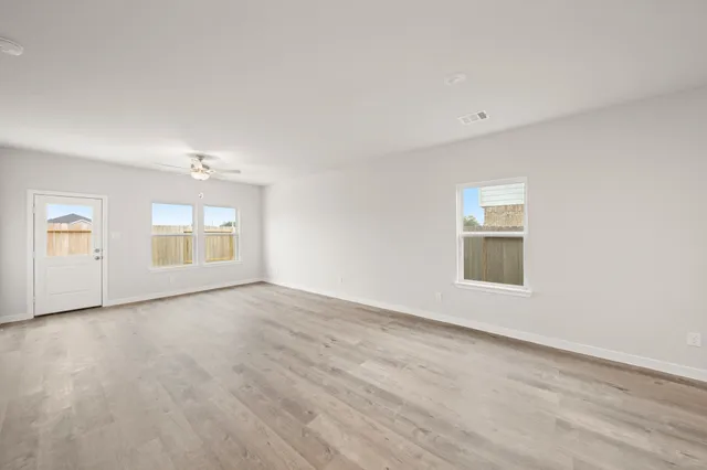 an empty room with a empty space and windows