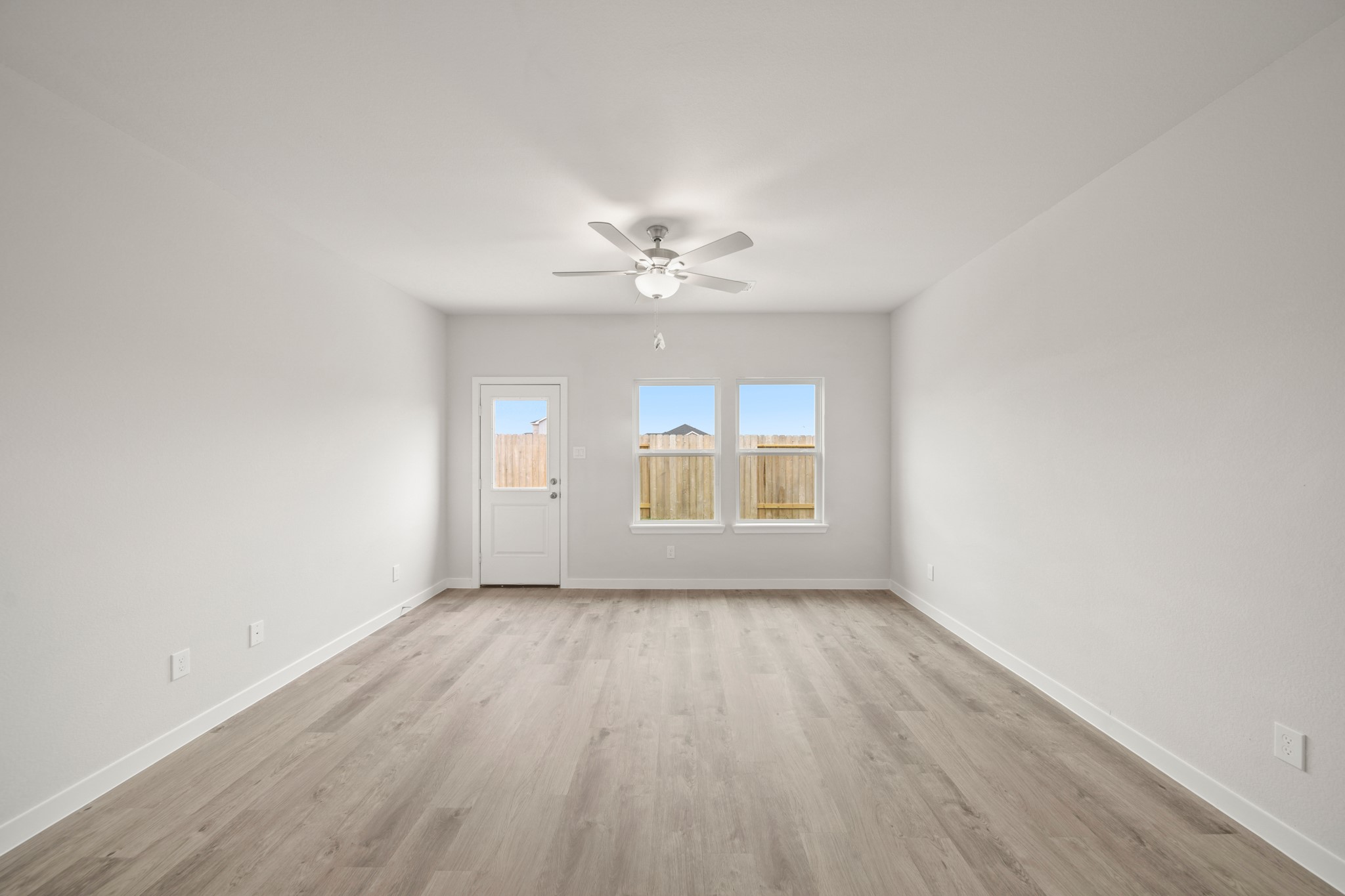 306 Bennett Street Angleton, TX 77515 - Photo 8 of 29 wooden floor in an empty room with a window
