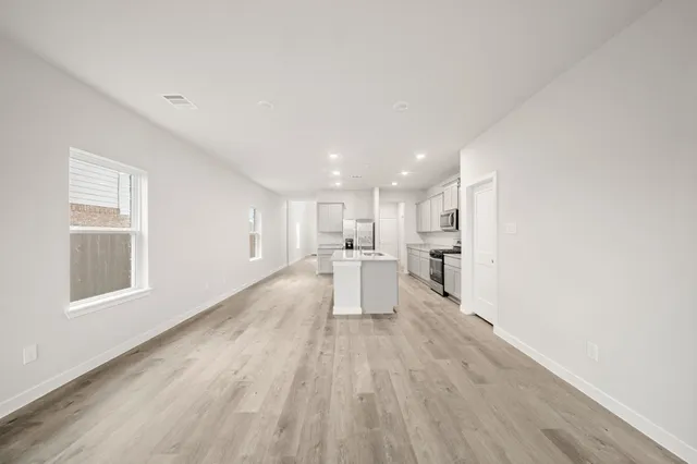 a view of a kitchen with wooden floor