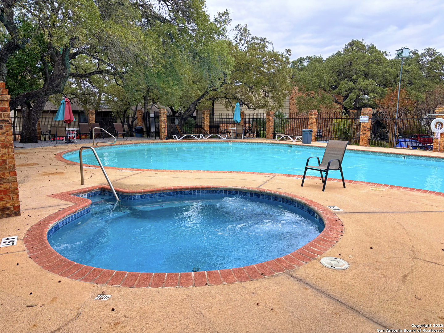 11815 Vance Jackson Road, Unit 1602 San Antonio, TX 78230 - Photo 2 of 24 a view of a swimming pool with a yard