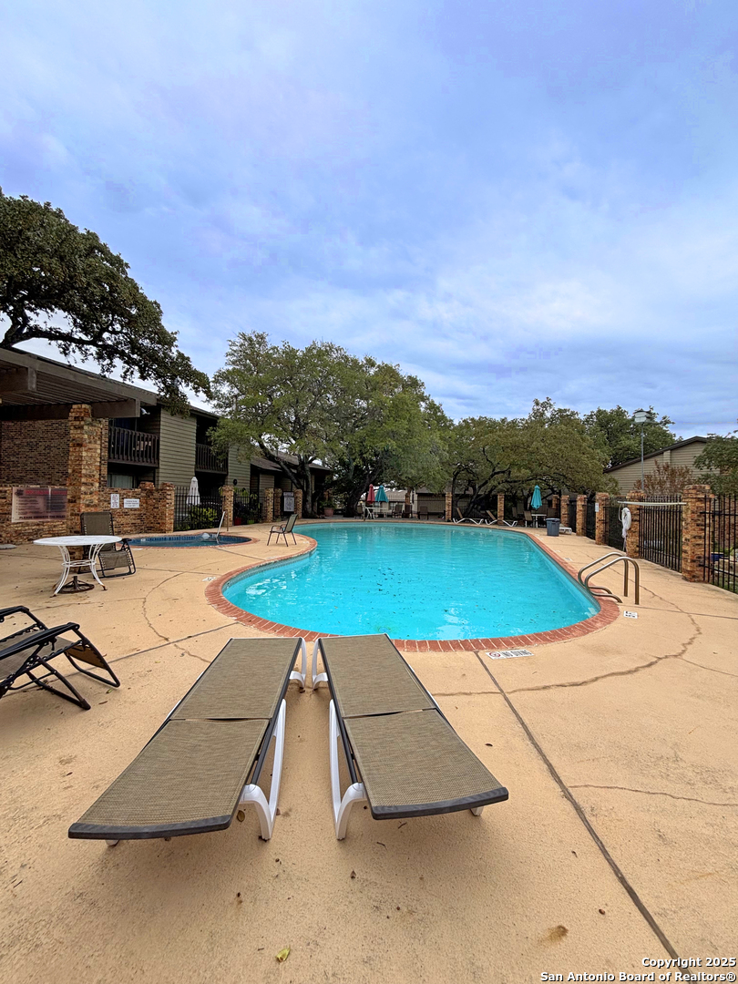 11815 Vance Jackson Road, Unit 1602 San Antonio, TX 78230 - Photo 23 of 24 an aerial view of a swimming pool with lounge chairs