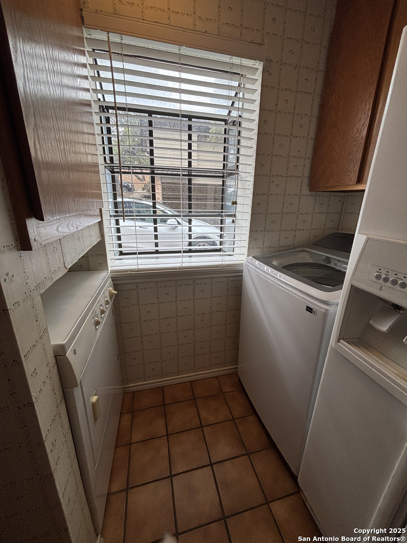 11815 Vance Jackson Road, Unit 1602 San Antonio, TX 78230 - Photo 6 of 24 a view of a storage and utility room with washing machine
