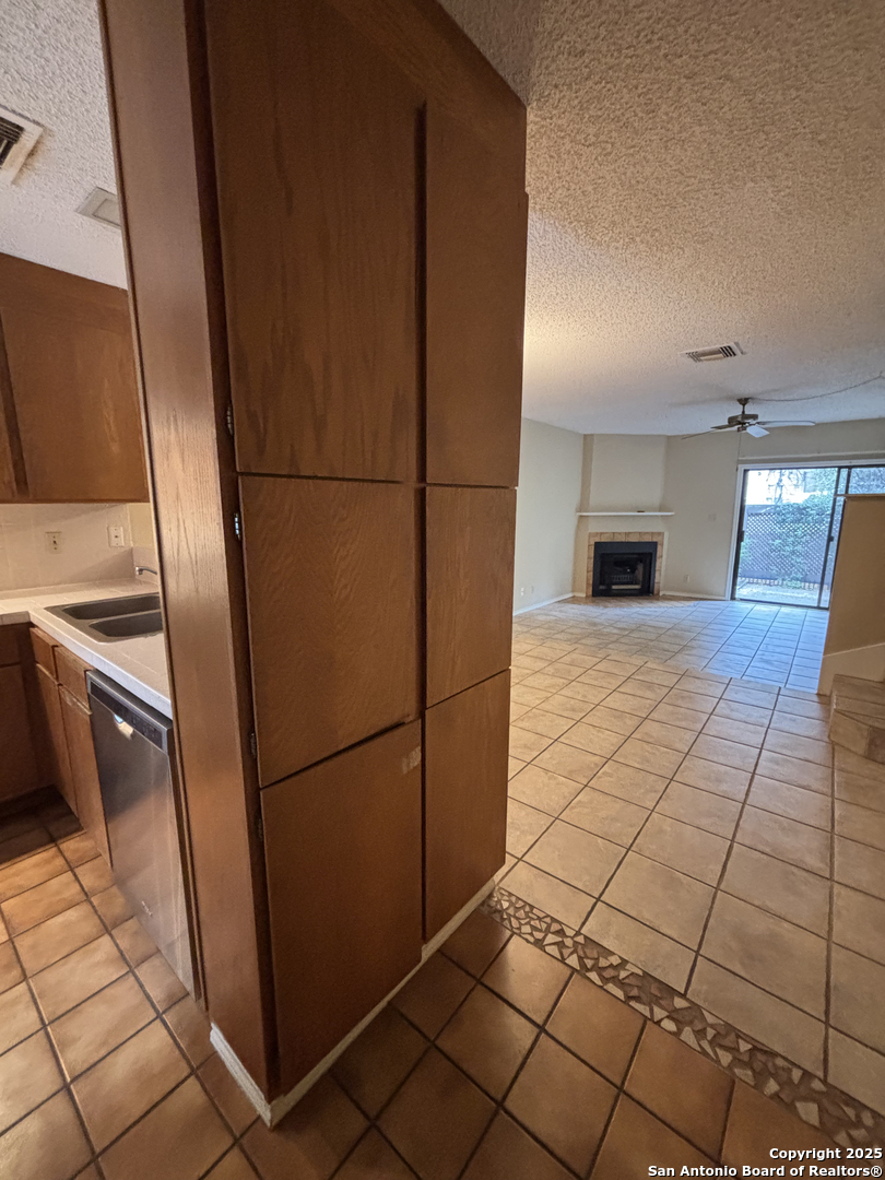 11815 Vance Jackson Road, Unit 1602 San Antonio, TX 78230 - Photo 7 of 24 a view of a refrigerator in kitchen and an empty room