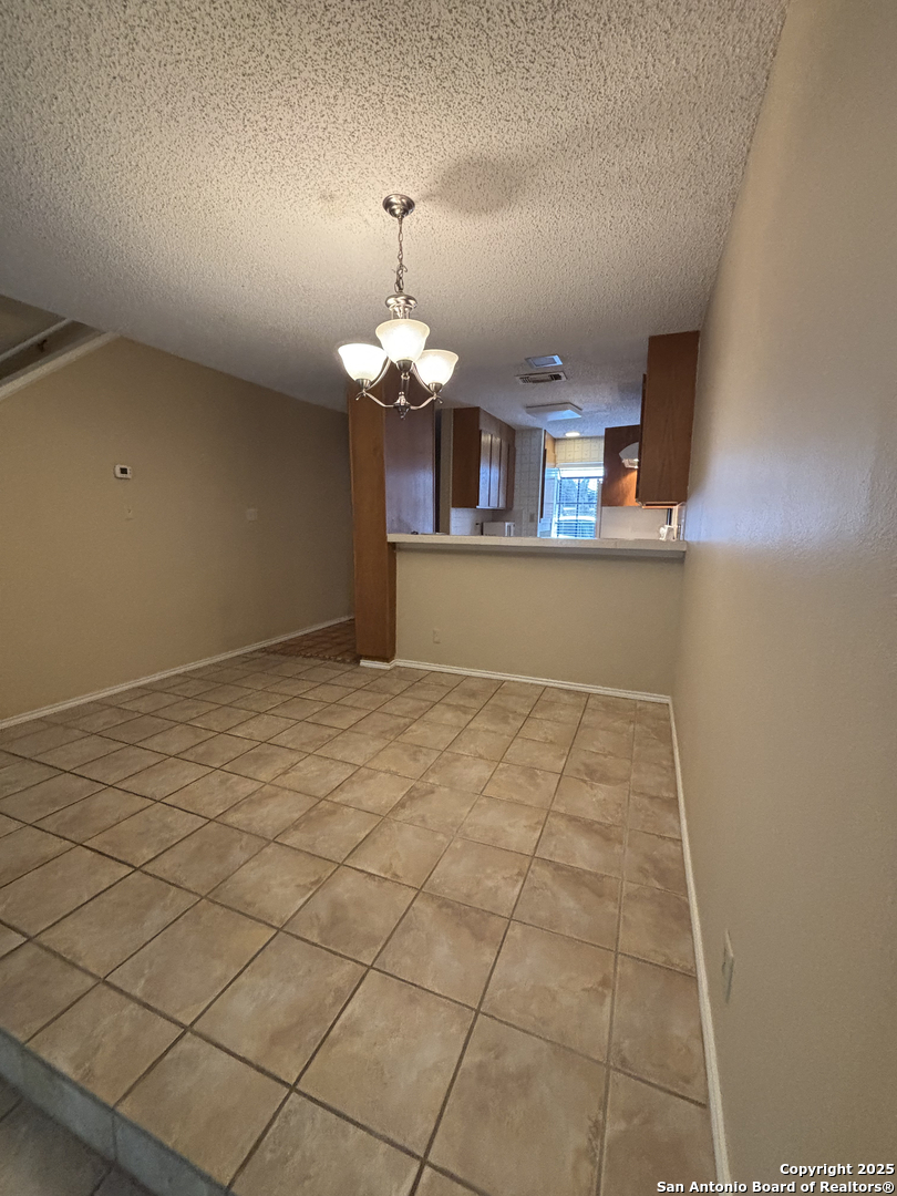 11815 Vance Jackson Road, Unit 1602 San Antonio, TX 78230 - Photo 10 of 24 an empty room with kitchen view