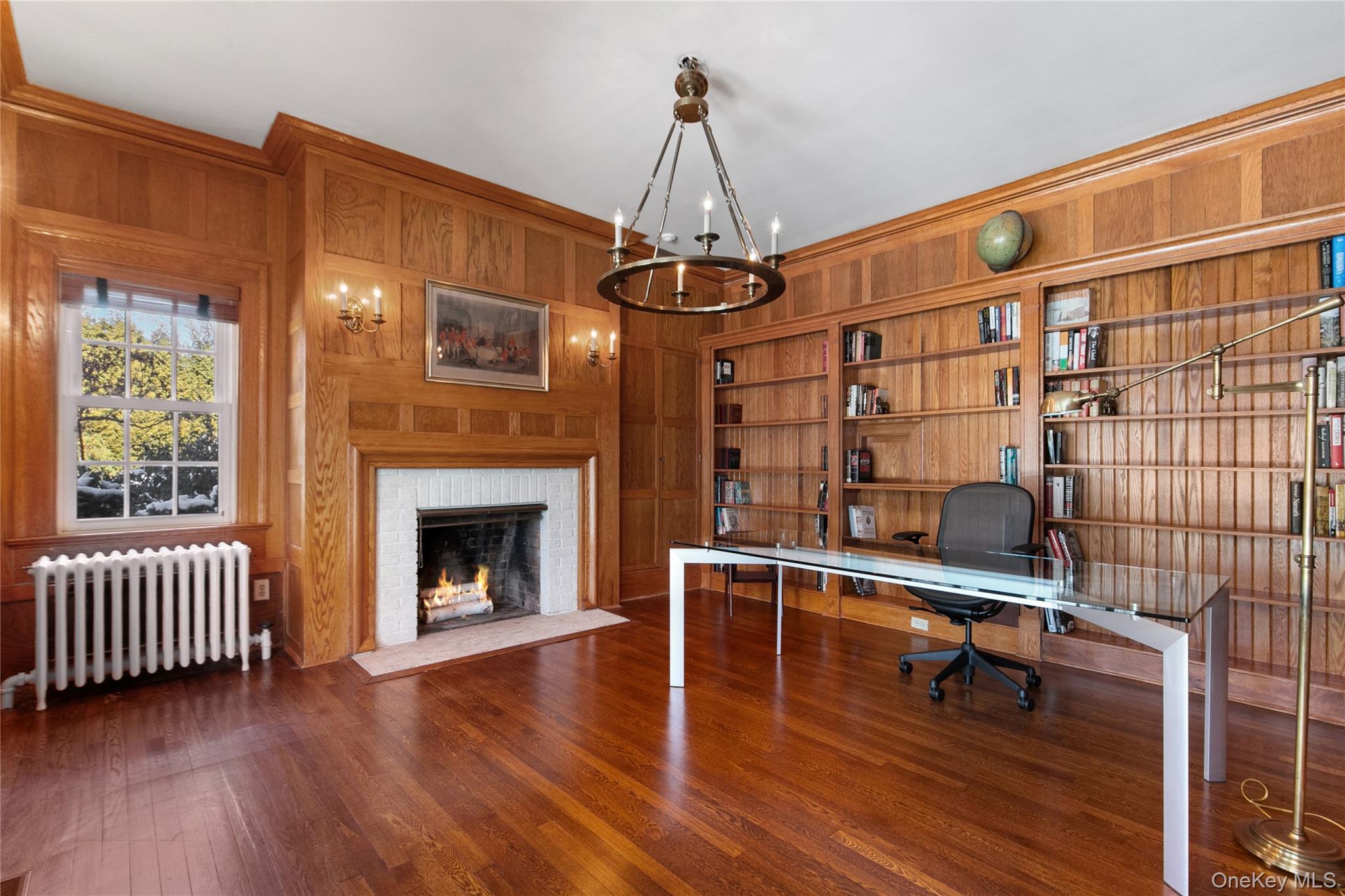 36 Revolutionary Road Briarcliff Manor, NY 10510 - Photo 21 of 50 Office area with hardwood floors, fireplace, wood paneled walls, built in shelves