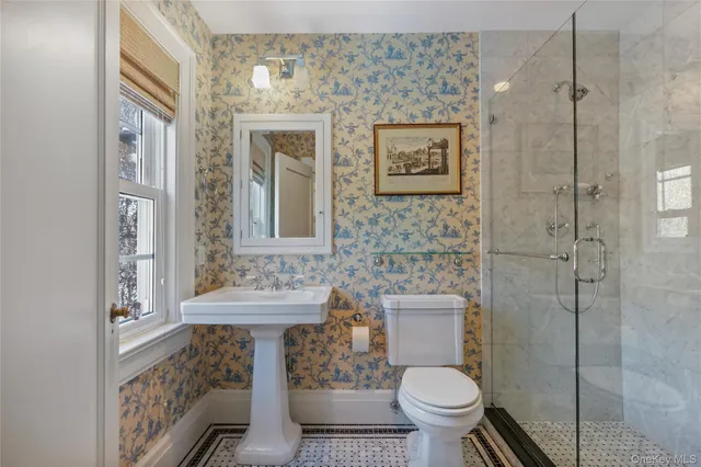 a bathroom with a toilet sink and mirror