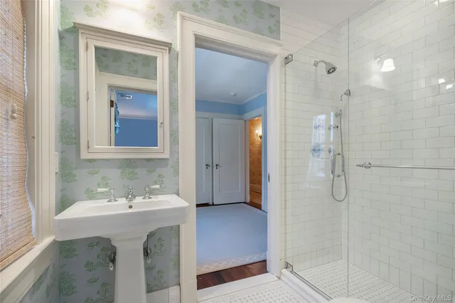 a bathroom with a shower sink and mirror