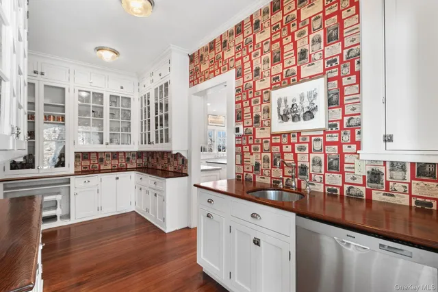 a kitchen with stainless steel appliances a sink and a large window