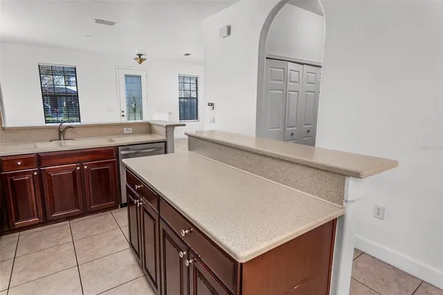 a kitchen with a sink a stove and cabinets