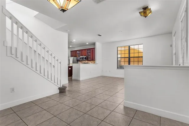 a view of a hallway with entryway and stairs