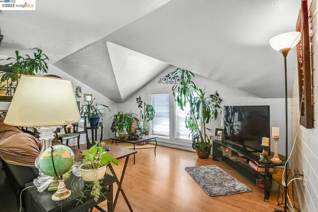 a room with furniture a rug and a flat screen tv