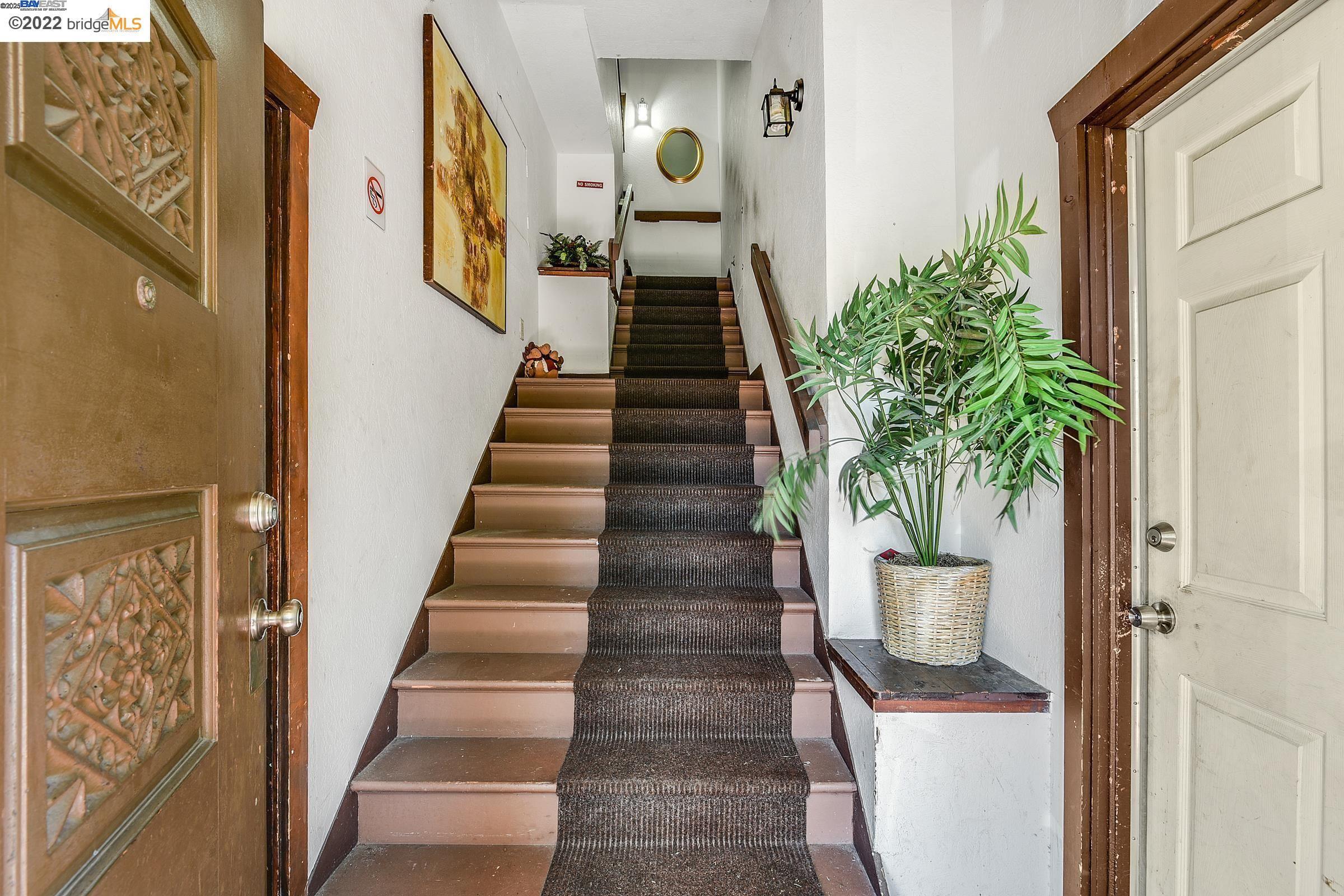 2550 Pleasant Street Oakland, CA 94602 - Photo 7 of 35 a view of a hallway with wooden floor and stairs