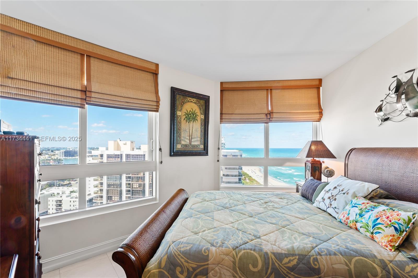 6365 Collins Avenue, Unit 1901 Miami Beach, FL 33141 - Photo 24 of 84 a bedroom with a large bed and a large window