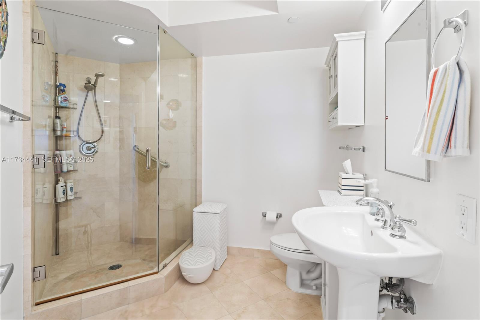 6365 Collins Avenue, Unit 1901 Miami Beach, FL 33141 - Photo 35 of 84 a bathroom with a sink toilet and shower