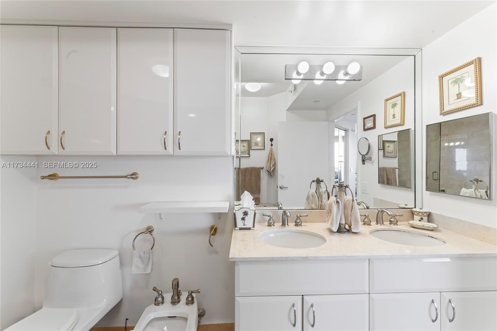 6365 Collins Avenue, Unit 1901 Miami Beach, FL 33141 - Photo 36 of 84 a bathroom with a sink vanity granite and toilet