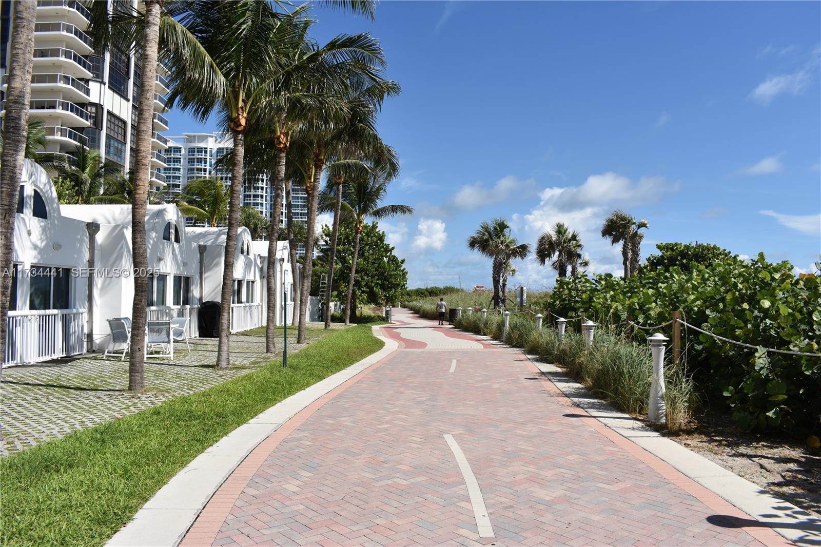 6365 Collins Avenue, Unit 1901 Miami Beach, FL 33141 - Photo 78 of 84 a front view of a house with a yard and potted plants